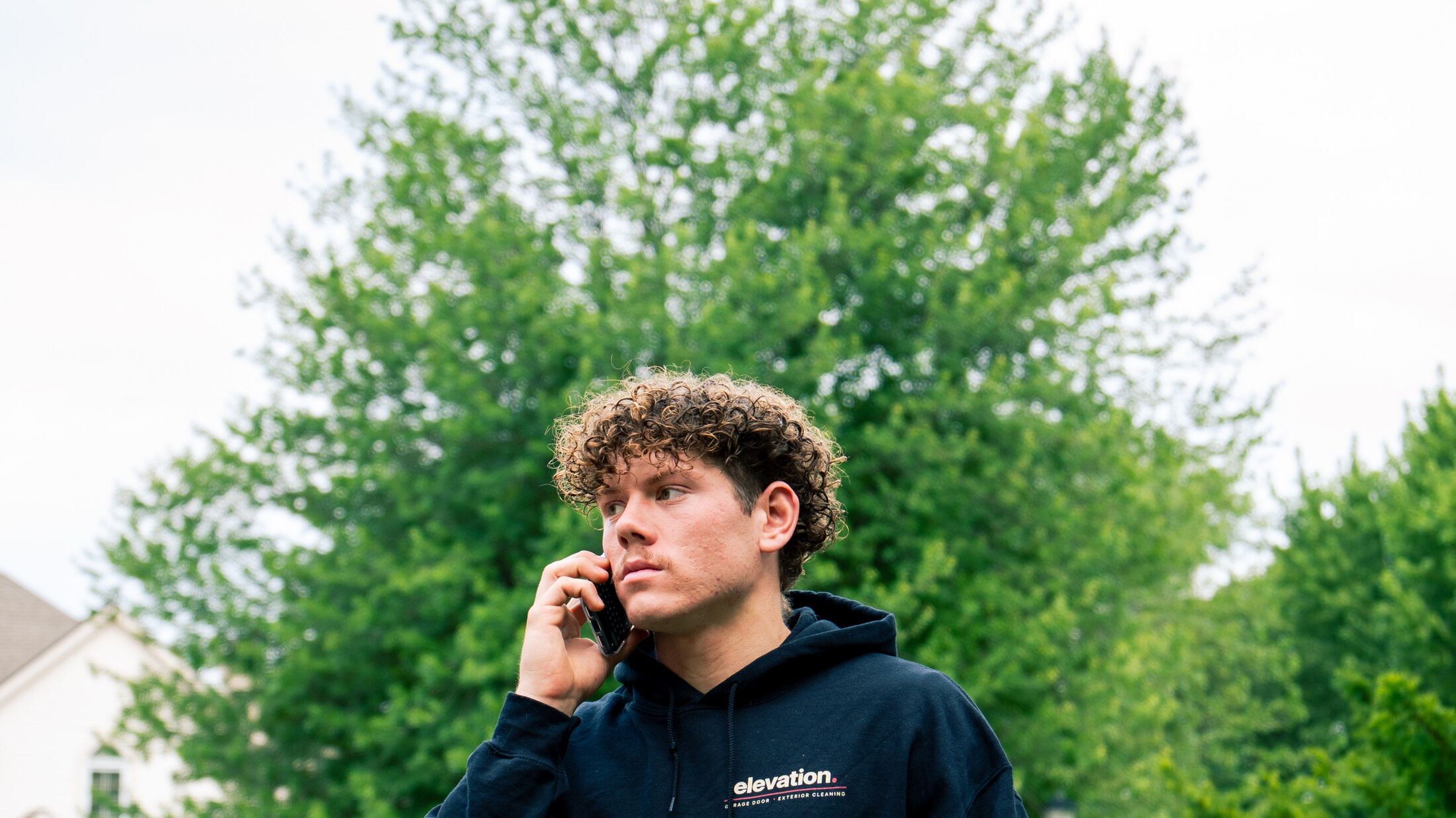 An Elevation team member taking a customer's call from a job in the Grand Rapids metro
